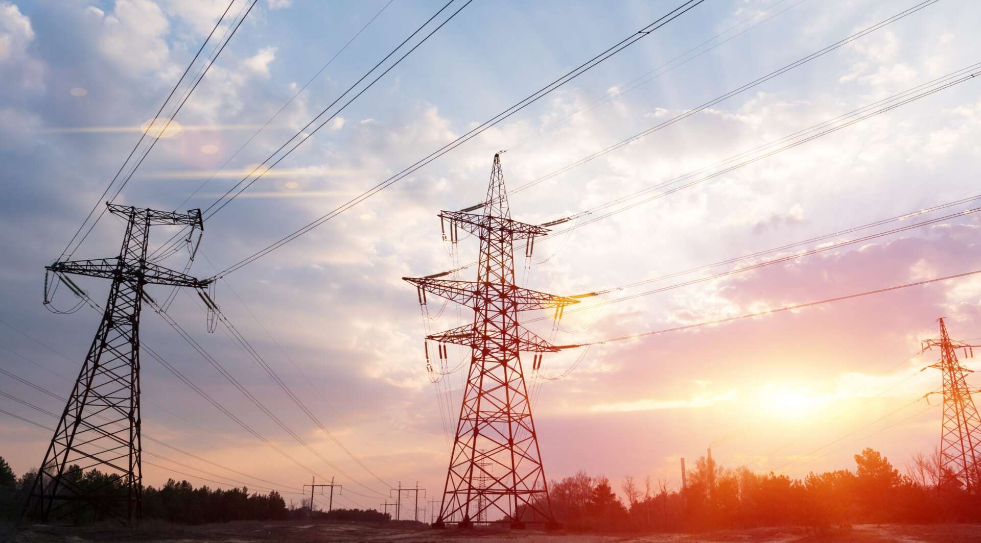 Highvoltage power lines at sunset or sunrise. High voltage electric